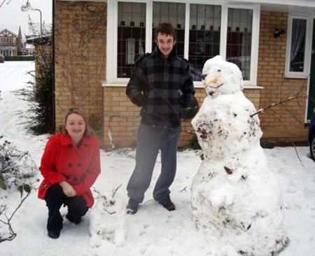 Building a snowman in Hedge End in the snow by Mel Adams