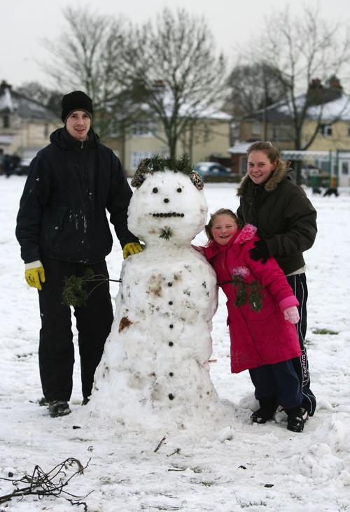 Gary and Kelly Burrows with Kelly's sister Courtney Donahoe, 5, and their snowman, Veracity ground, Sholing