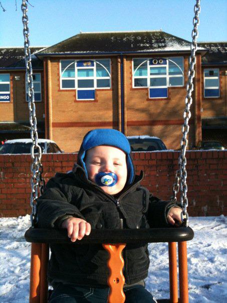 My 1 year old Son Charlie... enjoying a Swing in the snow! by Sarah Kosten.