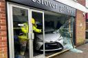 Elderly woman smashes into gallery shop window.