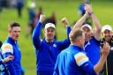 Justin Rose, left, celebrates Europe's victory with teammate Henrik Stenson, centre