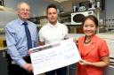 Andy Piller, centre, presents the cheque to Drs David and Bee Flavell of Leukaemia Busters