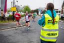 A milemaker cheering on runners at last year's event