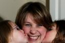 KISS OF LIFE: Lorraine Robinson, pictured with her daughters Naomi and Abigail, who were vaccinated against swine flu following a campaign in the Daily Echo. Echo picture by Matt Watson. Order no: 10167455