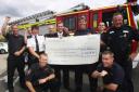 PC Gary Morgan (right) and colleagues hand over the big cheque for the James Shears and Alan Bannon Memorial Fund to firemen at St Mary’s Station. The money was raised at an event for members of the emergency services at the Oceana night club.