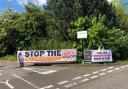 Activists unveil the banner outside the entrance to Hounsdown Business Park in Totton.