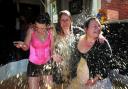 GUNGED: Nikki Henderson Corrine Walsh and Jan Henderson in a bath of beans and cornflakes at The Griffin pub fundraising event. Right, James Shears and Alan Bannon who died in a tower block fire. Order no. 10269402