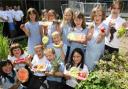 HEALTHY EATING: Children at Bitterne CE Junior School learn about fresh fruit with Bupa volunteers, back left, as  part of the Activ-eat initiative. 	Echo picture by Chris Moorhouse. Order no: 10674671