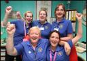 Nursing staff celebrate after the cardiac unit is saved