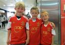 Three young Saints fans enjoy getting their hands on the new shirt on the day it came out.