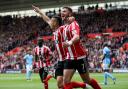 Shane Long and Dusan Tadic celebrate against Manchester City