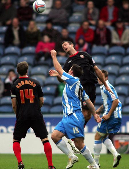 Danny Seabourne wins an aerial challenge against Huddersfield.