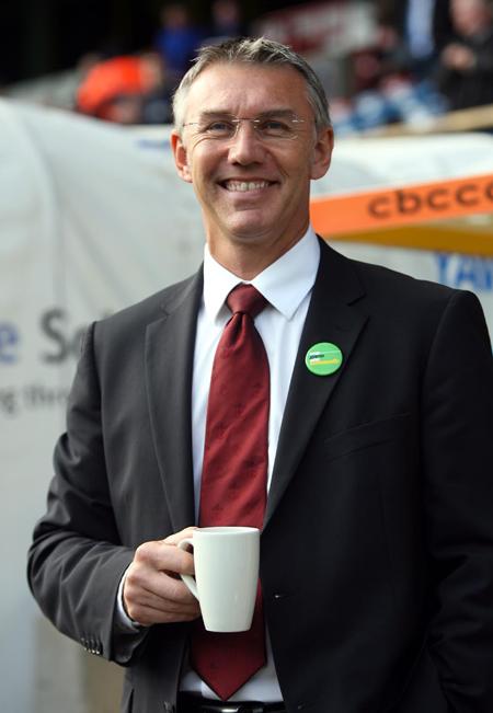 Nigel Adkins prepares for the match with a cup of tea