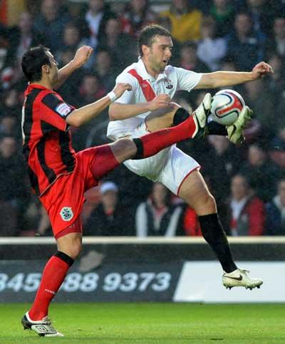 Rickie Lambert in an aerial challenge with Liam Ridehalgh. A selection of images from the Southampton versus Huddersfield Town League One match on December 28, 2010 at St. Mary's Stadium