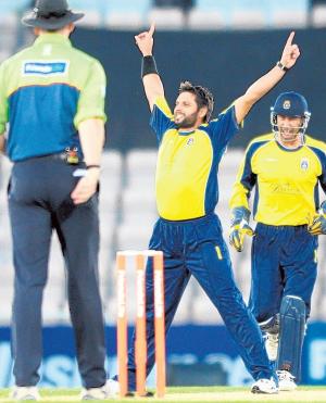 Shahid Afridi, above, takes his second wicket in his first over