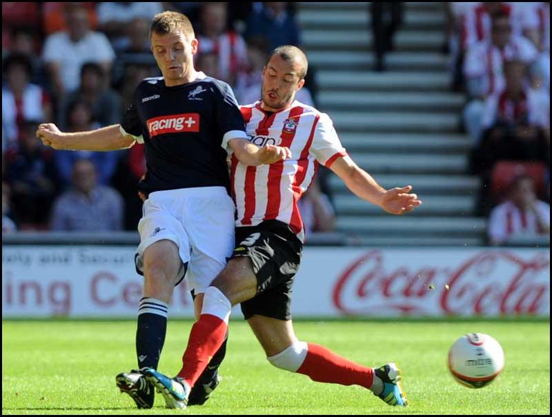 Steve De Ridder tackles Tony Craig. Photos from Saints Championship match against Millwall on Saturday, August 20, 2011
