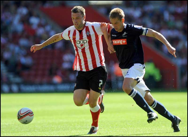 Rickie Lambert fends off the challenge of Paul Robinson. Photos from Saints Championship match against Millwall on Saturday, August 20, 2011