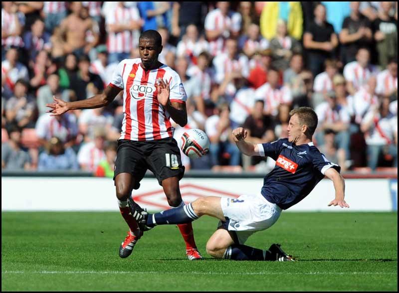 Guly Do Prado rides Tony Craig's challenge. Photos from Saints Championship match against Millwall on Saturday, August 20, 2011