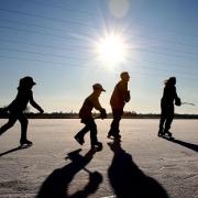 Children skating on a frozen lake