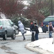 CLOSE RANGE: A gang of youths run into the road throwing snowballs at passing cars in Meggeson Avenue in Townhill Park.