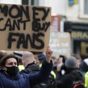 Chelsea fans protest against Chelsea's decision to be included amongst the clubs attempting to form a new European Super League before the English Premier League soccer match between Chelsea and Brighton and Hove Albion outside Stamford Bridge