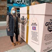 Mia Gordon donating using the giving box at Whiteley shopping centre, Fareham, 1st April 2021.