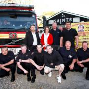 WREATH: Liam Ryan, front centre, with Redbridge firefighters and the owners of The Saints pub in Millbrook. Echo picture by Stuart Martin.               Order no 10303521