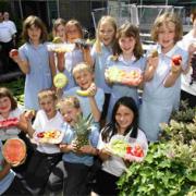 HEALTHY EATING: Children at Bitterne CE Junior School learn about fresh fruit with Bupa volunteers, back left, as  part of the Activ-eat initiative. 	Echo picture by Chris Moorhouse. Order no: 10674671