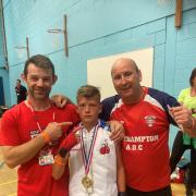 Double gold medallist Lylee Buckland, centre, with coach Dave Craddock and Gary White