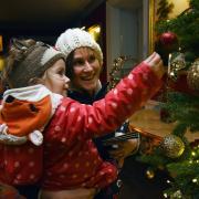 A mother and child enjoying the National Trust Christmas decorations