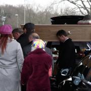 Family bow their heads at the arrival of the coffin of Teresa Grimes, landlady of the West End Brewery. The funeral was held at Wessex Vale Crematorium. Picture by Stuart Martin