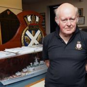 Lt Cdr Retd Mark Brady WITH a model of the County Class Destroyer HMS London.