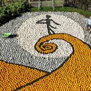 Tom Nelson of Sunnyfields Farm in Totton, Hants puts the finishing touches to a giant artwork paying tribute to Tim Burton's The Nightmare Before Christmas on its 30th anniversary, using 10,000 pumpkins and squash.