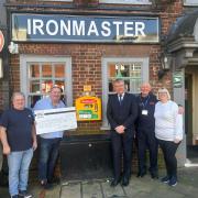 Fareham Borough council leader Cllr Sean Woodward joins the teams from The Ironmaster and The Alex Wardle Foundation to launch the pub's new defibrillator