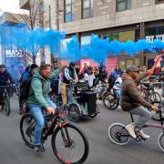 Dom sets off from Guildhall Square accompanied by fellow cyclists who produced large amounts of coloured smoke