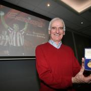 Hugh Fisher shows off his FA Cup winner's medal at an Ex Saints event