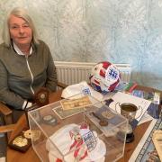 Louise with some of the memorabilia she has collected over the years