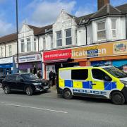Police officers swarm shop on Shirley Road