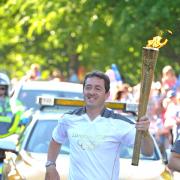 Chris Boardman, carrying the Olympic Torch