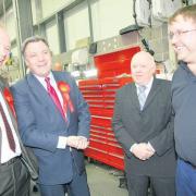 Shadow Chancellor Ed Balls and Labour contender John O’Farrell, left, meet Hendy service director Ian Dowie and foreman James Morgan.