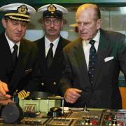 ON THE BRIDGE: The Duke of Edinburgh with Captain Paul Wright and chief engineer Brian Whattling, during his tour of the QM2 ten years ago.