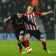 Adam Lallana, left, tangles with James Ward-Prowse.