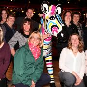 Marwell’s Zany Zebra on stage of the Mayflower Theatre stage with Mayflower Theatre’s staff.