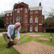 Lt Col Colin Bulleid with crosses for the 1280 men of the Hampshire Regiment who died in the Somme campaign, pictured in the memorial garden at Serle's House, Winchester