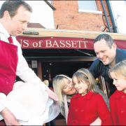 Butcher Simon Broadribb show the turkey to the Hewer family