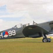 FOR SALE: With the MkIX two-seat Spitfire is Peter Tuplin, managing director of Classic Aero engineering at Thruxton Airfield, near Andover.
