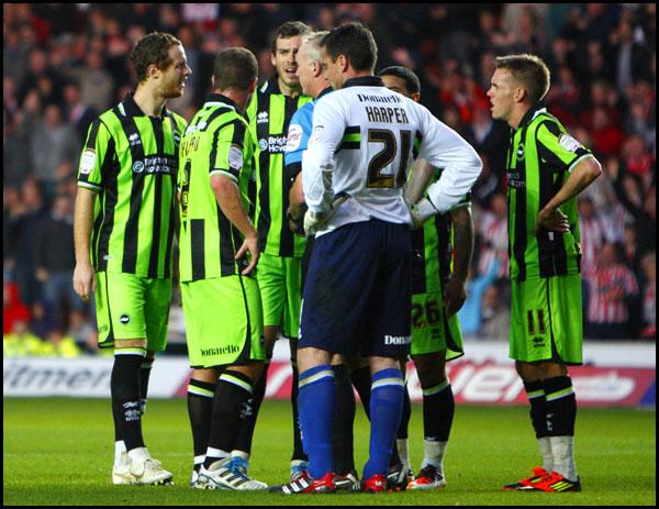 Saints v Brighton and Hove Albion, Brighton players argue with the referee after Saints were awarded a penalty.