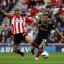 FIRST TO THE BALL: Sunderland’s Steven Fletcher bids to halt Liverpool’s Joe Allen at the Stadium of Light on Saturday