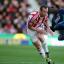 ROSE PICKED OFF: Danny Rose takes a tumble under a challenge from Charlie Adam