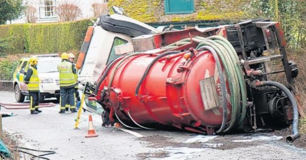 Fire crews with the stricken lorry in Leckford Lane, Stockbridge.